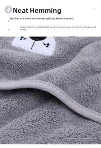 Detail of coral fleece baby bath towel featuring neat edge stitching and cute embroidery