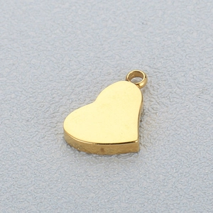 Macro shot of a polished gold-finish heart pendant charm for DIY jewelry making
