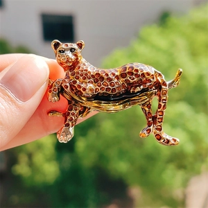 Detail of leopard brooch featuring golden enamel spots and textured alloy finish