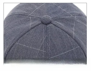 Macro shot of navy baseball cap crown featuring fine grid pattern and reinforced stitching