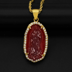 Detail of oval gold pendant with red Virgin Mary relief and sparkling rhinestones