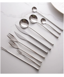 Flat lay of polished 304 stainless steel cutlery set on white marble surface