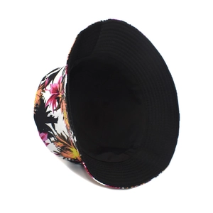 Detail of reversible bucket hat showing floral print and black inner lining fabric