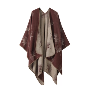 Deep red knit poncho shawl with beige lining and ginkgo leaf pattern texture