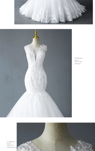 Detailed view of white mermaid wedding dress with lace appliques and sequin mesh