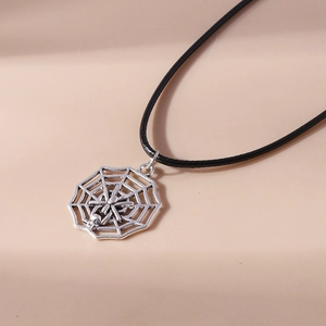 Detailed close-up of a silver spider web pendant with a skull on a black cord necklace