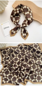 Detail of a brown silk-satin scarf with geometric shield pattern and smooth glossy finish