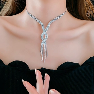 Close-up of French-style Y-shaped tassel necklace with silver diamond-studded design