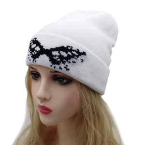 White knit beanie for women with black geometric butterfly pattern and warm ribbed texture