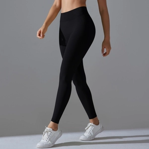 Detail of high-waisted black yoga leggings with ribbed waistband and seamless knit texture