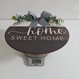Weight measurement of wooden Home Sweet Home sign with striped bow and greenery