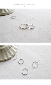 Macro detail of S925 sterling silver fine rings with twisted rope texture and silver finish