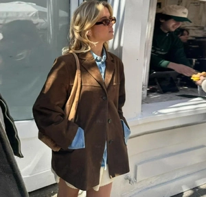 Brown faux suede jacket detail featuring classic buttons and street style outdoors