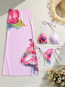 Detailed view of 3-piece floral bikini set with halter top and matching sheer maxi skirt