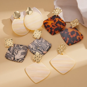 Collection of geometric acrylic drop earrings with animal prints and golden metal studs