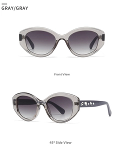 Detail of gray oval sunglasses featuring crystal-encrusted temples and gradient lenses