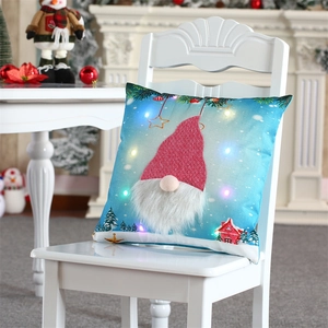 Detail of blue LED Christmas pillow cover featuring gnome with red sequin hat on chair