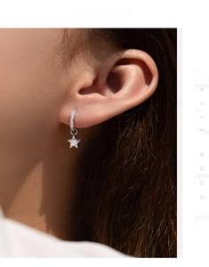 Detailed close-up of S925 sterling silver star drop earrings with sparkling moissanite stones