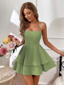 Detailed view of grass green cotton dress featuring layered ruffles and thin straps