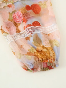 Close-up of floral chiffon sleeve with lace patchwork and elastic cuffs for women