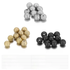 Macro shot of 7mm and 9mm frosted stainless steel faceted beads in gold, black, and silver