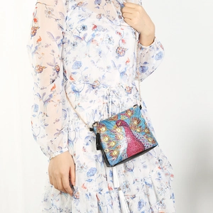 DIY diamond painted chain bag with a vibrant peacock pattern and black fringe tassel
