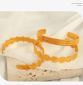 Three-piece gold adjustable cuff bracelet set with star and wave patterns on stone