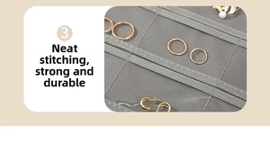Detail of grey jewelry organizer showing durable stitching and clear mesh pockets