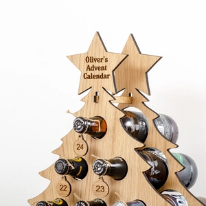 Close-up of wooden Christmas tree advent calendar wine rack with numbered tags