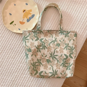 Detail of floral cotton tote bag with Simple Wish label on quilted background