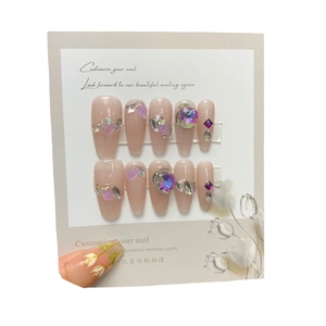 Handmade aurora press-on nails with purple rhinestones and nude pink glossy finish