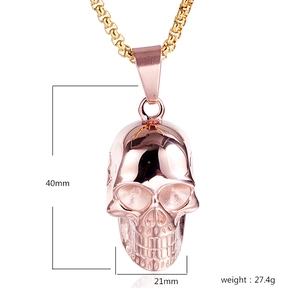 Detailed view of rose gold skull pendant measuring 40mm by 21mm on a gold box chain
