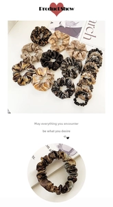 Macro detail of various satin scrunchies featuring leopard prints and metallic textures