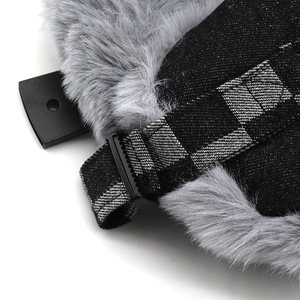 Macro detail of faux fur lining and checkered adjustable strap with buckle on aviator hat