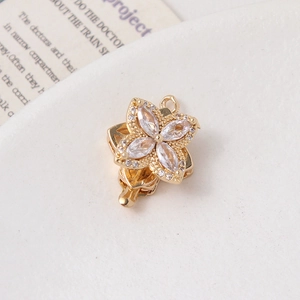 Detail of gold four-leaf clover connector with marquise cubic zirconia for jewelry