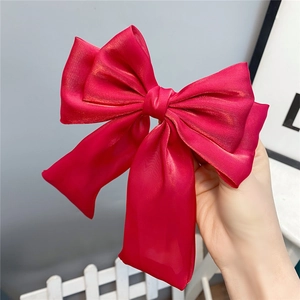 Elegant large red shimmering triple-layered bow hair clip with flowing long ribbons