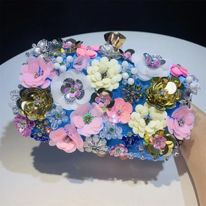 Detailed close-up of 3D floral beads and sequins on the sky blue satin evening bag