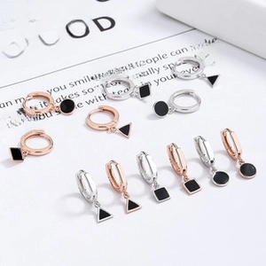 Detail of S925 sterling silver geometric earrings set with black enamel inlay details