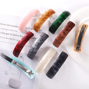 Detailed back view of colorful acetate hair clips with durable metal spring fasteners