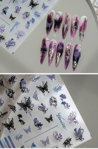 Detailed butterfly and floral nail stickers on stiletto nails with city names