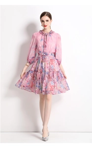 Macro detail of the ruffled stand collar and drawstring neckline on floral chiffon dress