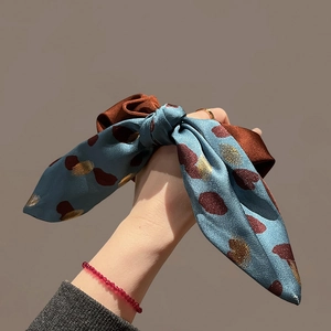 Elegant blue and brown satin bow scrunchie with artistic dot prints for hair styling