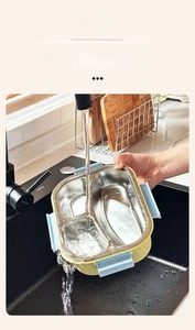 Detail of detachable 3-compartment 304 stainless steel lunch box liner being washed in sink