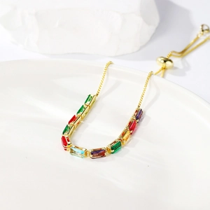 Macro detail of adjustable gold bracelet with colorful marquise-cut zircon stones