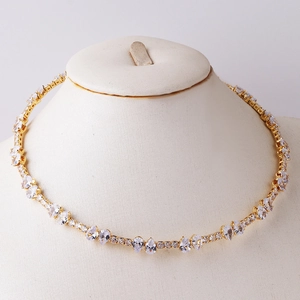 Elegant gold choker necklace featuring heart and teardrop cubic zirconia on a mannequin