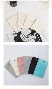 Detailed close-up of velvet jewelry pouches in various colors with snap button closures