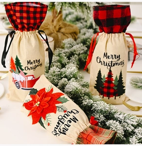 Detail of burlap Christmas wine bottle bag with red truck and festive floral patterns