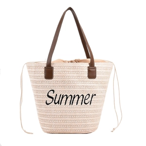 Large beige woven straw tote bag with Summer embroidery and dark brown handles