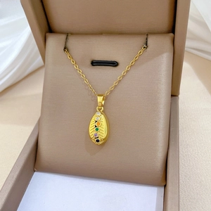 Macro detail of gold titanium necklace pendant with six colorful gradient gemstones