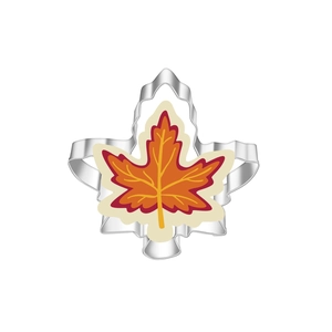 Macro detail of maple leaf stainless steel cookie cutter with colorful iced cookie